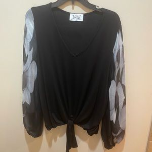 VaVa black blouse with white and black sheer sleeves.